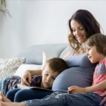 Pregnant Mom reads and cuddles with 2 sons