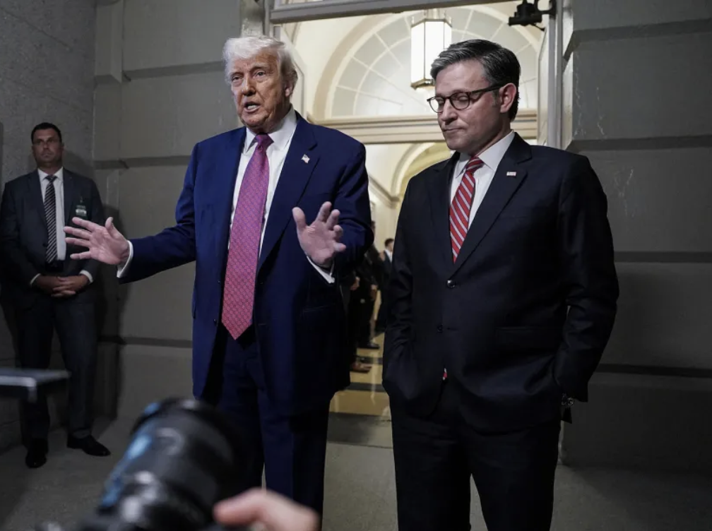 President Donald Trump next to House Speaker Mike Johnson-R La