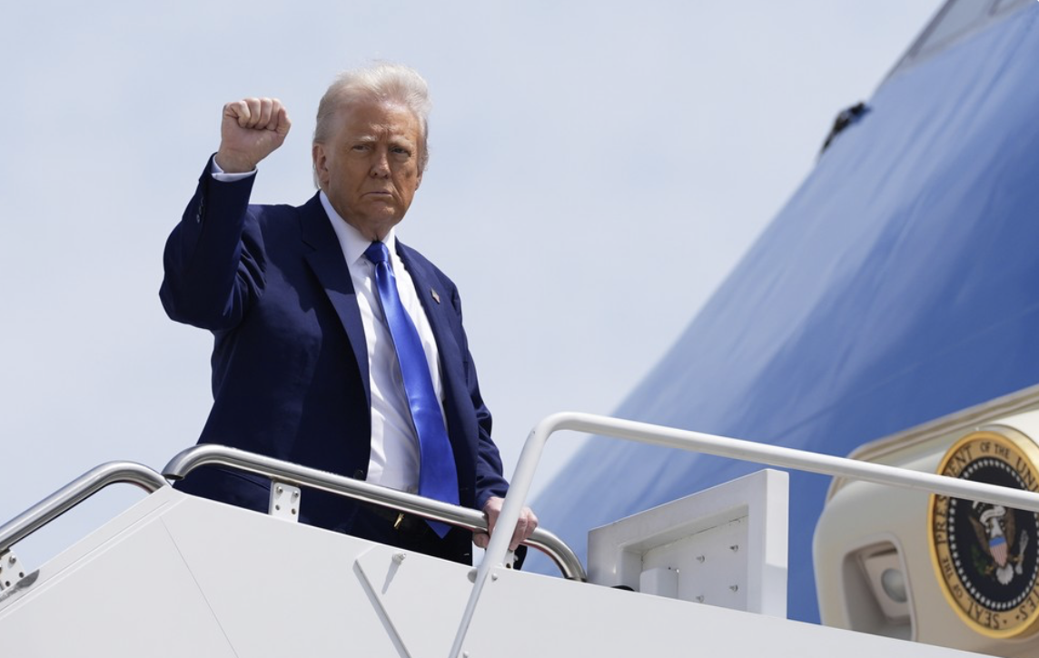 Trump fist pump as he boards Air Force One
