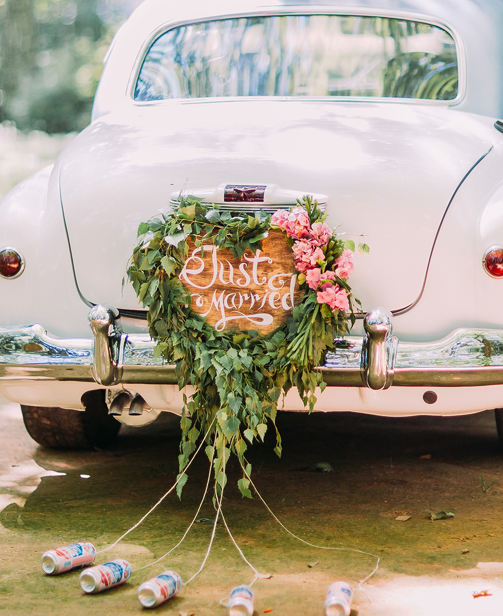 Vintage wedding car with just married sign and cans attached, close-up Vintage wedding car with just married sign and cans attached.jpg
