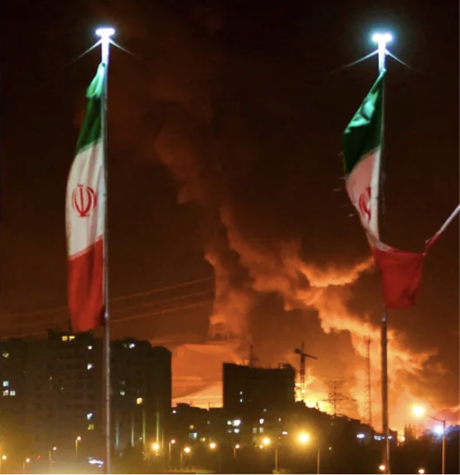 Iranian flags with fire and smoke rising