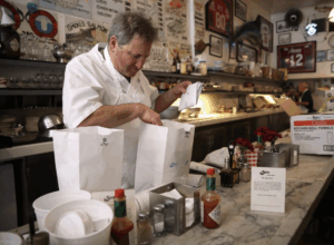 Tom Sancimino fills to-go orders at Swan Oyster Depot - targetted for cancellation