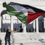 protester waves Palestinian flag outside LAPD
