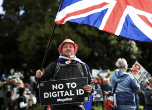 protester holds a Union Jack flag and 'No to Digital ID' sign - Liverpool