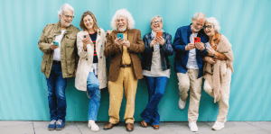 Baby boomers in a row on their phones