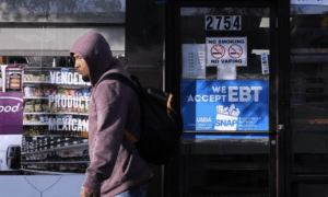 Hungry man walking past SNAP store