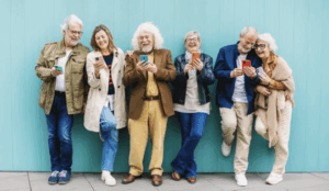 Baby boomers in a row on their mobile phones