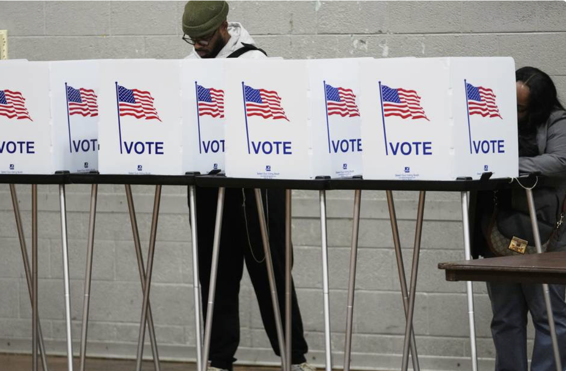 2 black people at voting stands