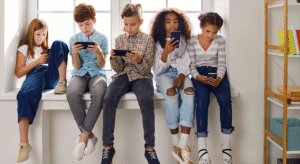 Children in a windowsill on their cellphones