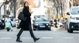 Woman crossing in a busy intersection